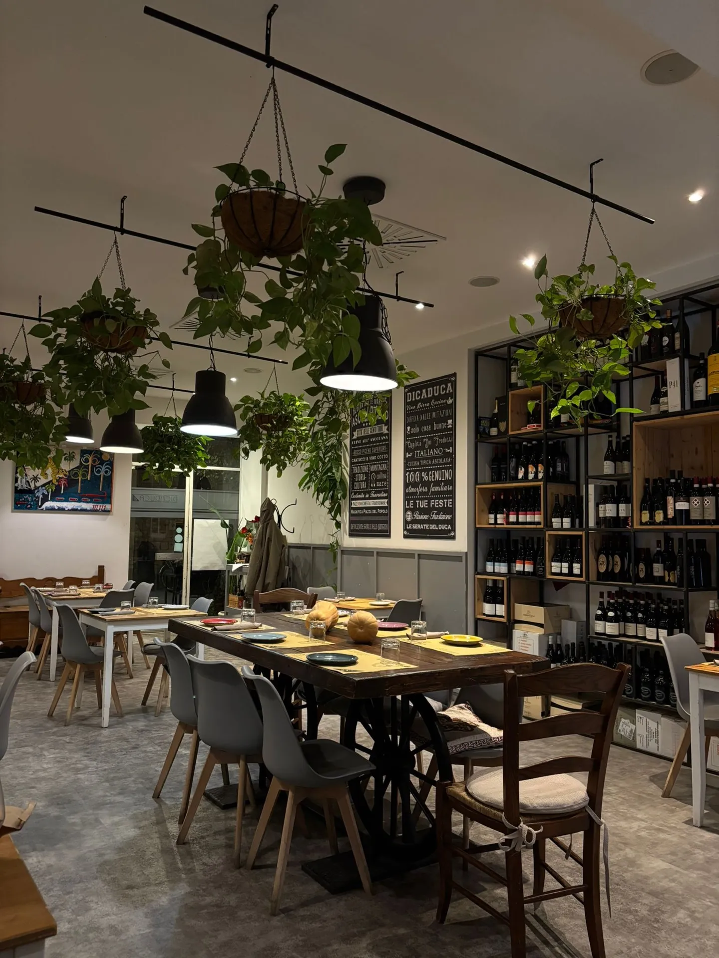 Tavolo conviviale di Dicaduca davanti alla lavagna dei vini